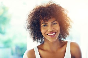 woman smiling after receiving dental treatment