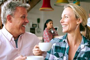 couple having tea and smiling at each other