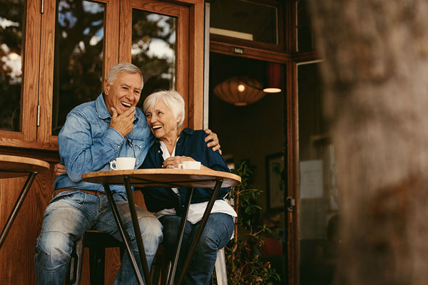 couple smiling with their new dental bridges