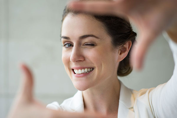 lady holding her hands up as if taking a picture